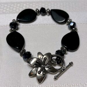 Beaded bracelet with unique flower clasp. Clasp closure is Silvertone.
